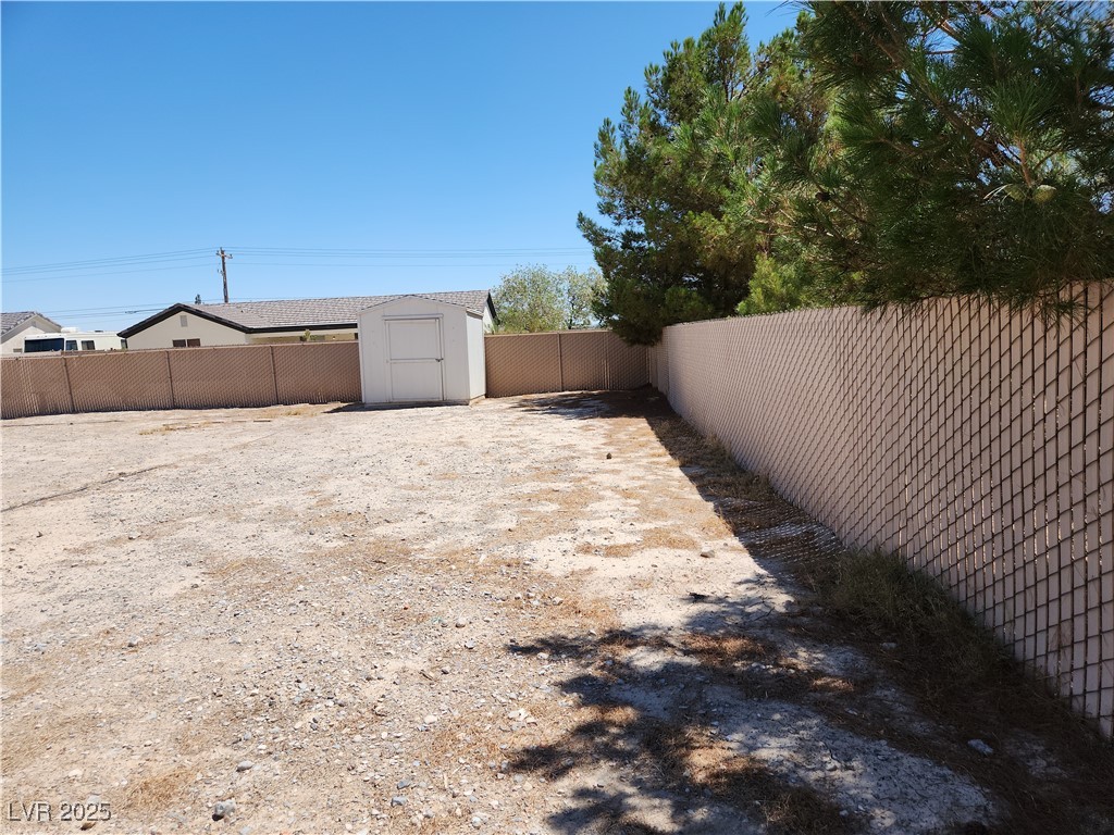 161 Diamond Bar Road Pahrump, NV 89048 - Photo 24 of 29 Fenced backyard with a storage unit
