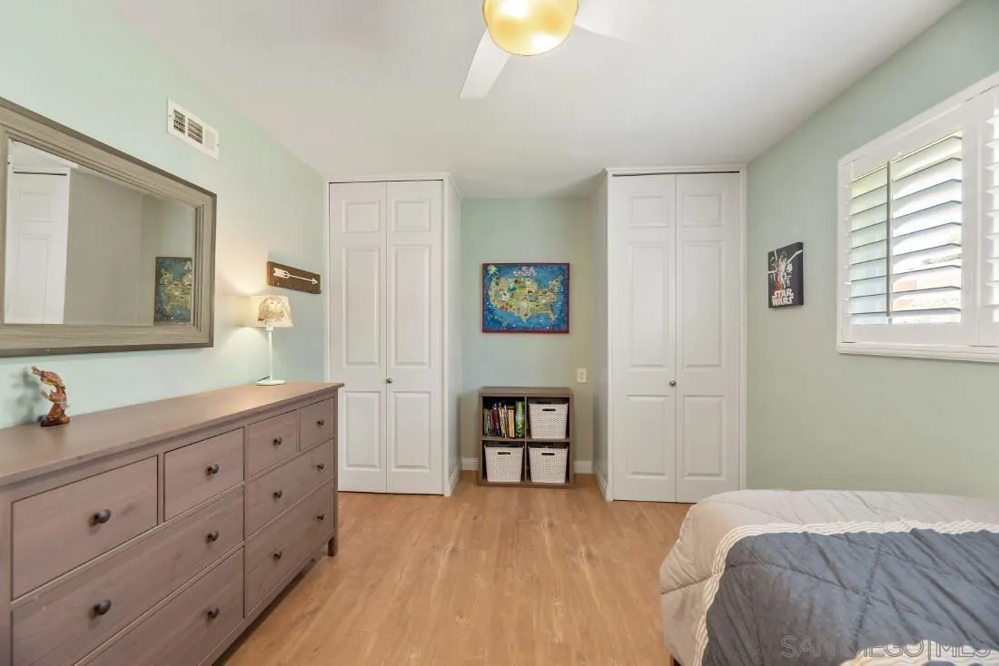 12730 Rios Road San Diego, CA 92128 - Photo 14 of 31 a bedroom with a bed and a dresser in it