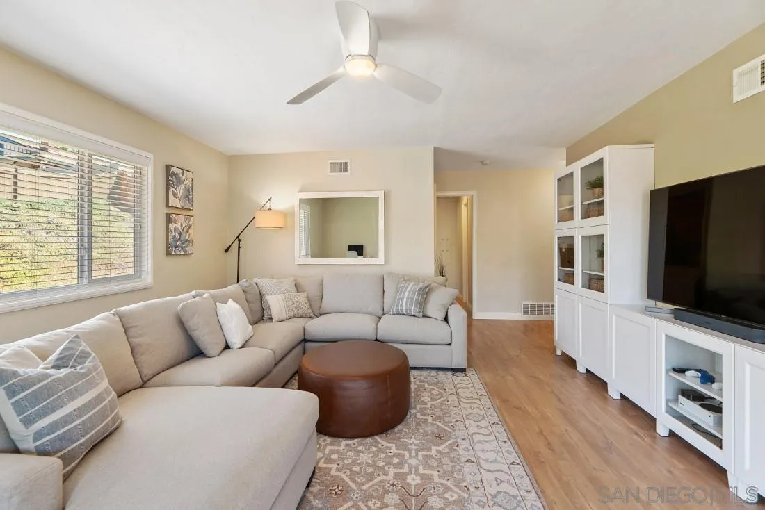 12730 Rios Road San Diego, CA 92128 - Photo 3 of 31 a living room with furniture and a flat screen tv