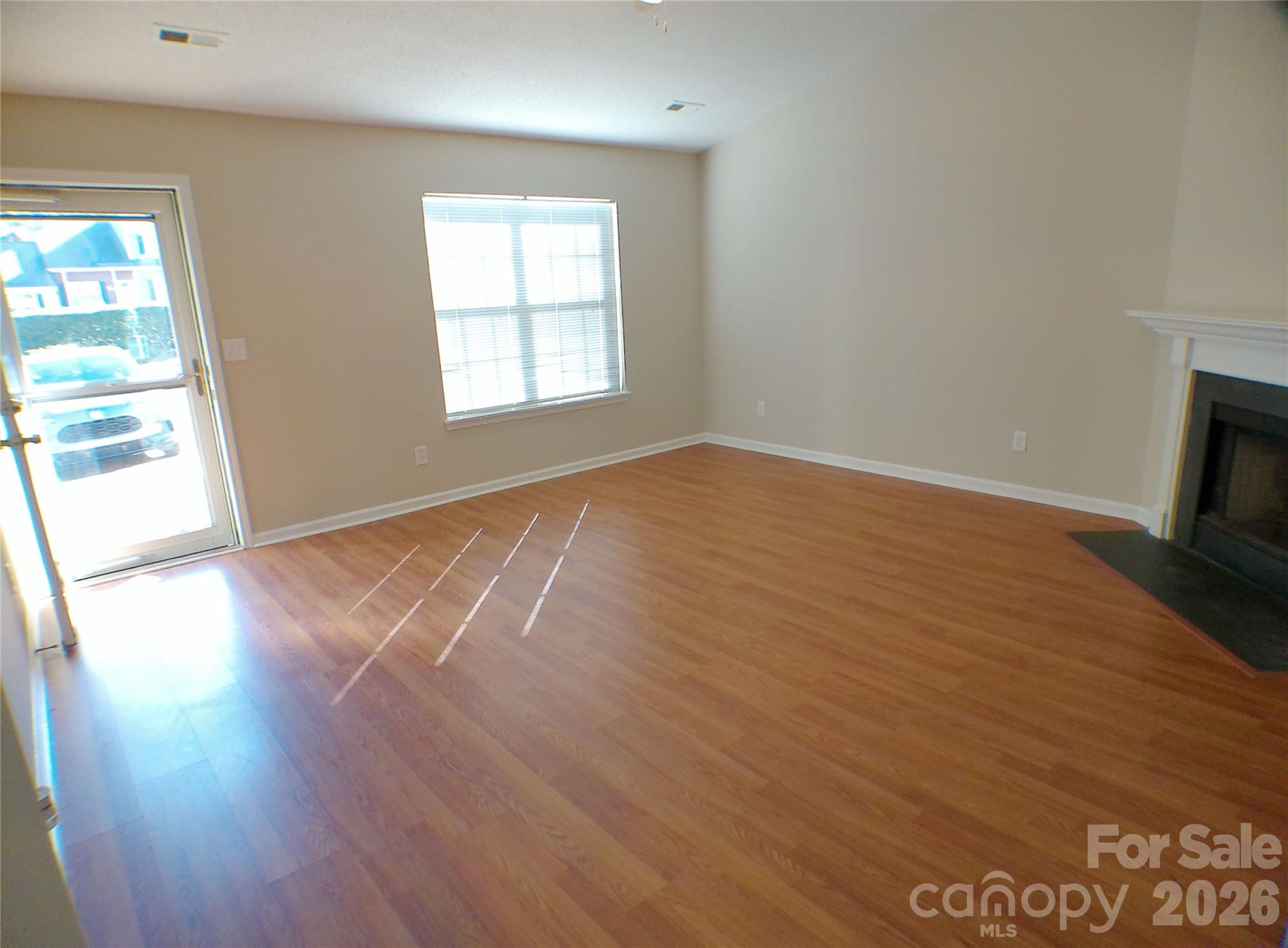 9112 4 Mile Creek Road Charlotte, NC 28277 - Photo 3 of 22 an empty room with wooden floor and windows