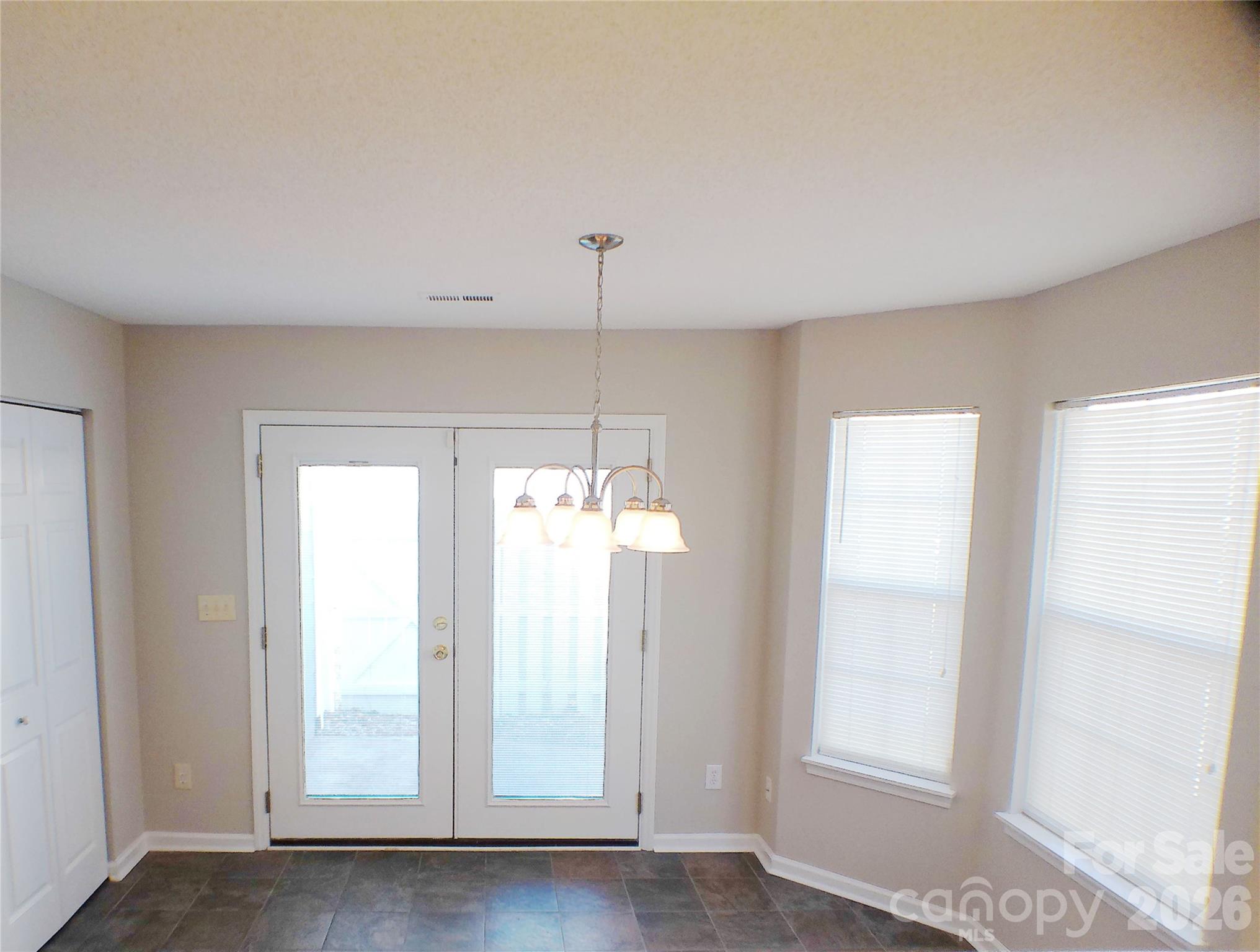 9112 4 Mile Creek Road Charlotte, NC 28277 - Photo 9 of 22 a view of an empty room with wooden floor and a window