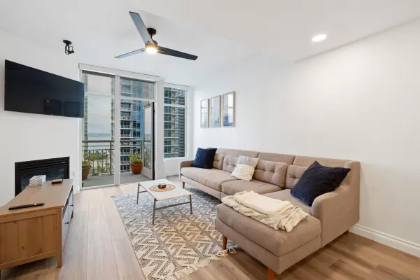 a living room with furniture a fireplace and a flat screen tv