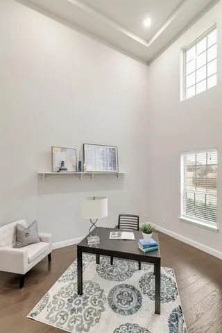 a view of a workspace with furniture and window