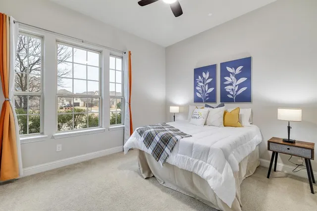 a bedroom with a bed and a large window