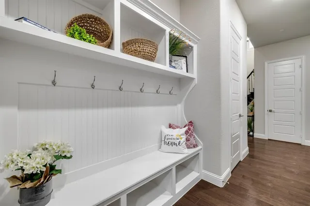 a hallway with painting on the wall