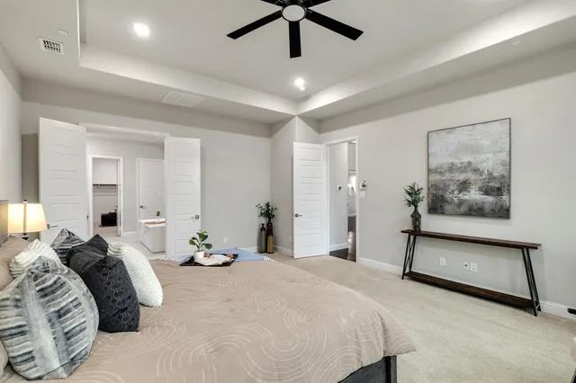 a bedroom with a bed and a painting on the wall