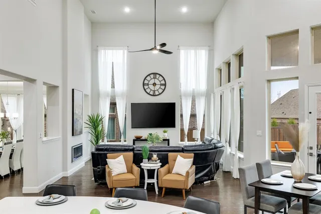 a living room with furniture a rug and a flat screen tv