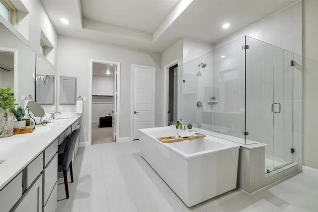 a bathroom with a tub sink shower and mirror