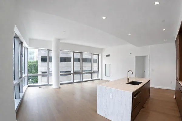 a kitchen with a stove and a large window