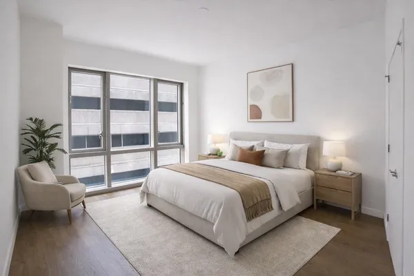 a bedroom with a large bed and a couch