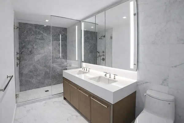 a bathroom with a sink toilet and shower