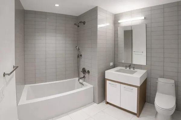 a bathroom with a sink toilet vanity and bathtub