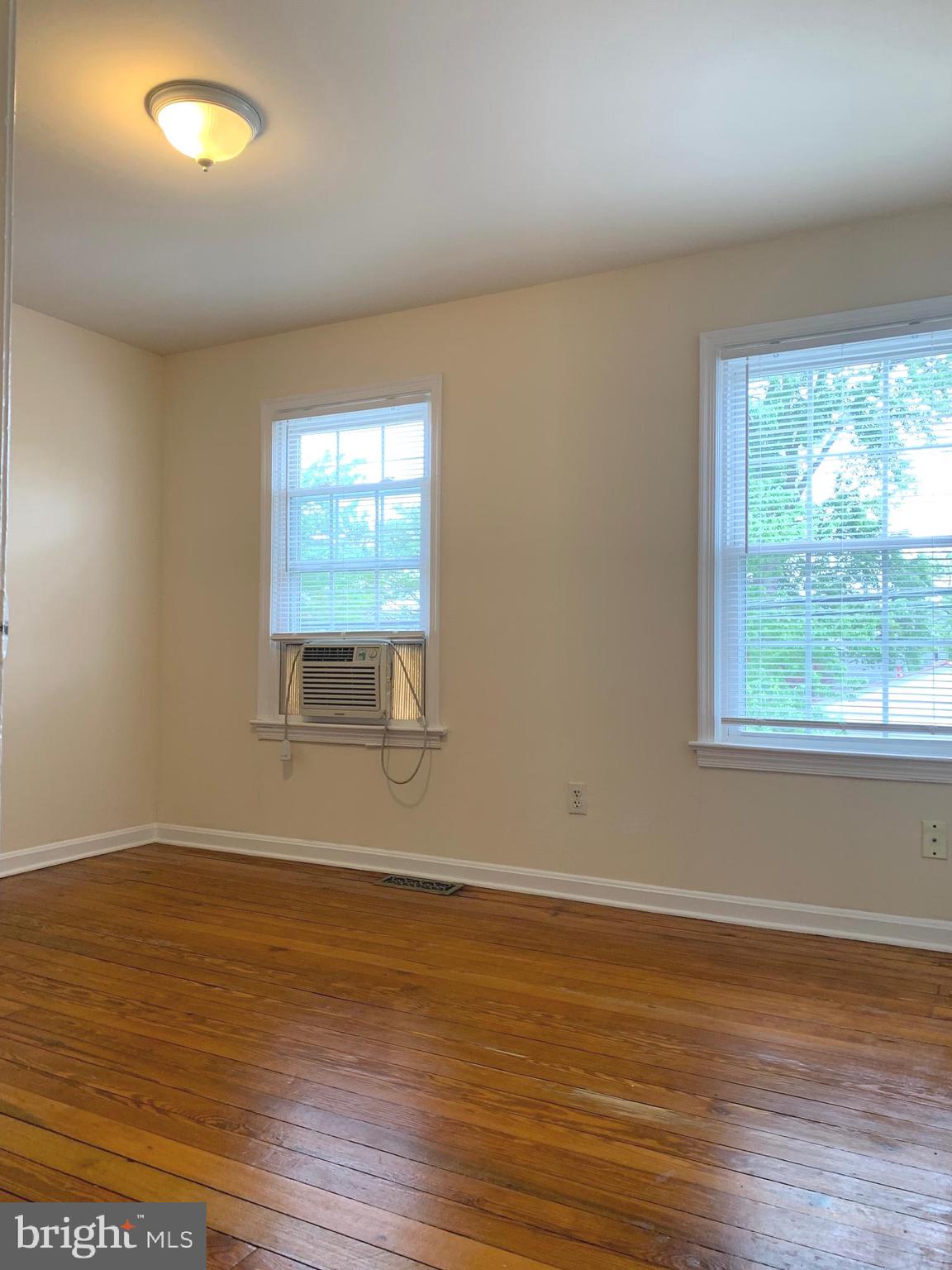 113 Hawke Street Fredericksburg, VA 22401 - Photo 7 of 10 a view of an empty room with wooden floor and a window