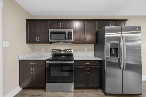 a spacious bathroom with a granite countertop sink and a mirror