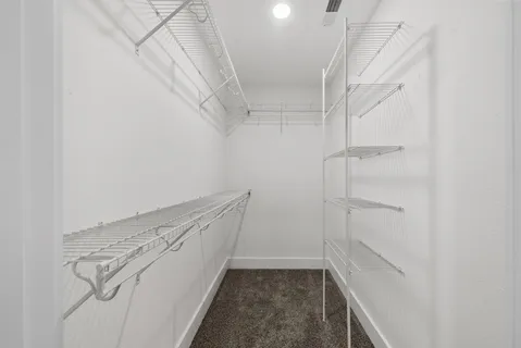 a bathroom with a granite countertop sink a toilet and a mirror