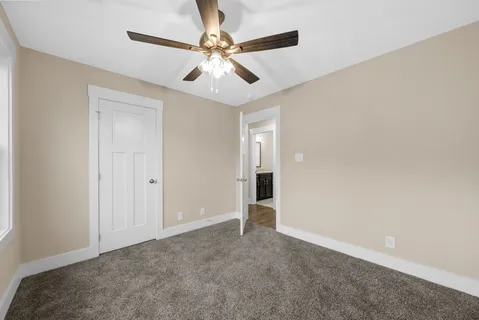 a bathroom with a granite countertop sink toilet a shower and a mirror