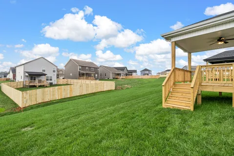 a front view of a house with a yard and porch