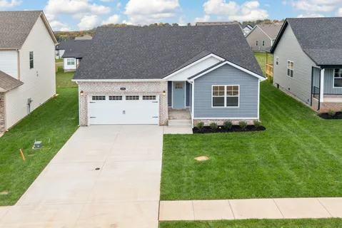 an aerial view of a house with a big yard