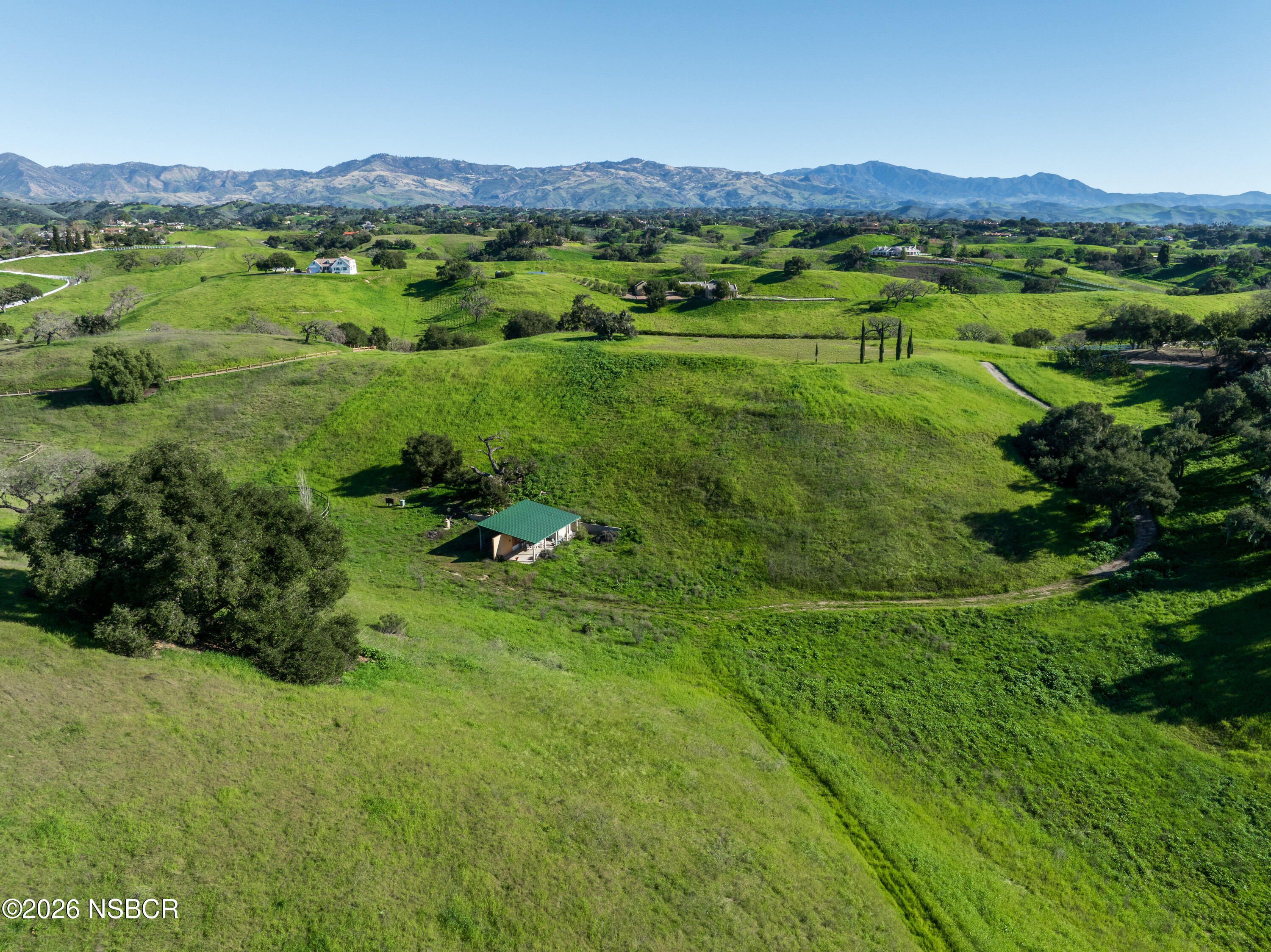 2865 North Refugio Road Santa Ynez, CA 93460 - Photo 19 of 37 a view of a lush green hillside and houses