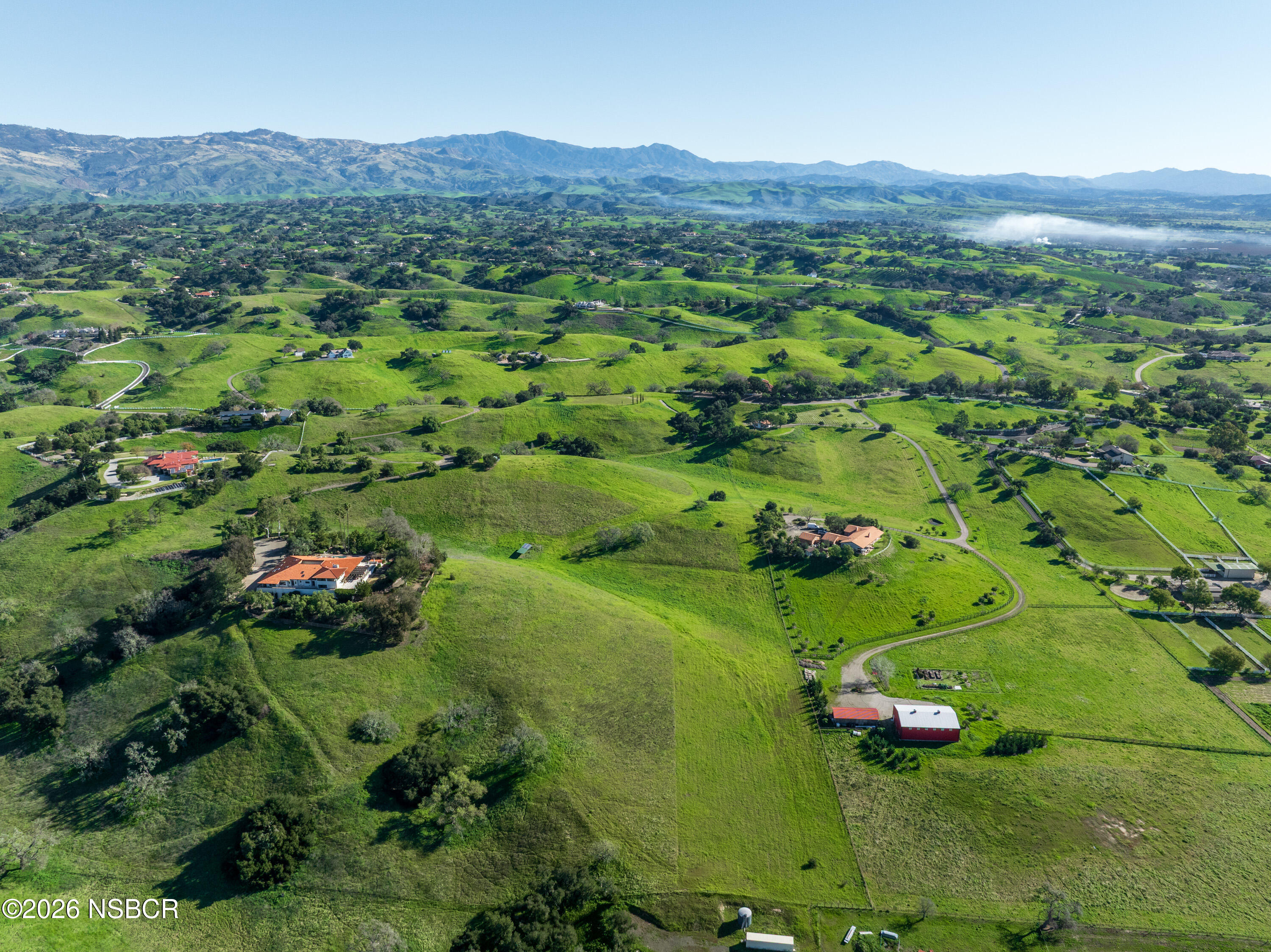 2865 North Refugio Road Santa Ynez, CA 93460 - Photo 6 of 37 a view of a lush green hillside and houses