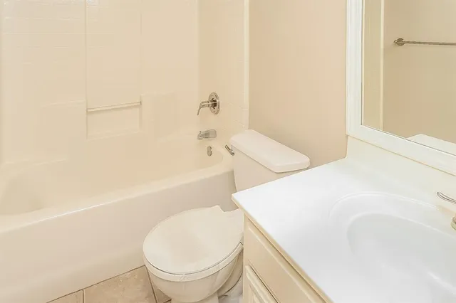 a bathroom with a sink a toilet and bathtub