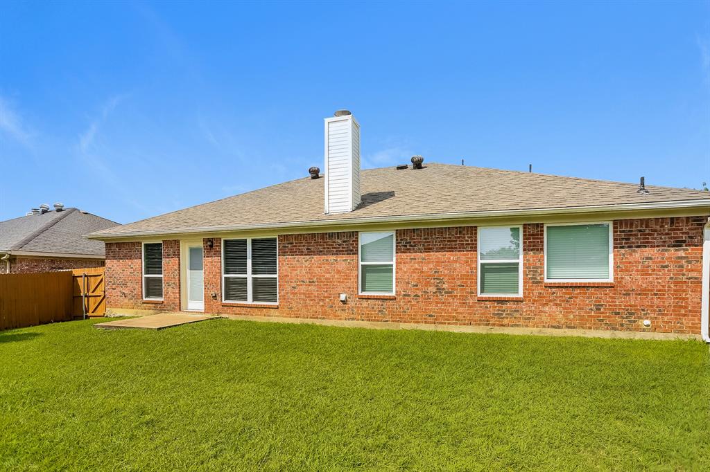 8009 Blue Duck Trail Arlington, TX 76002 - Photo 15 of 16 a front view of a house with a garden