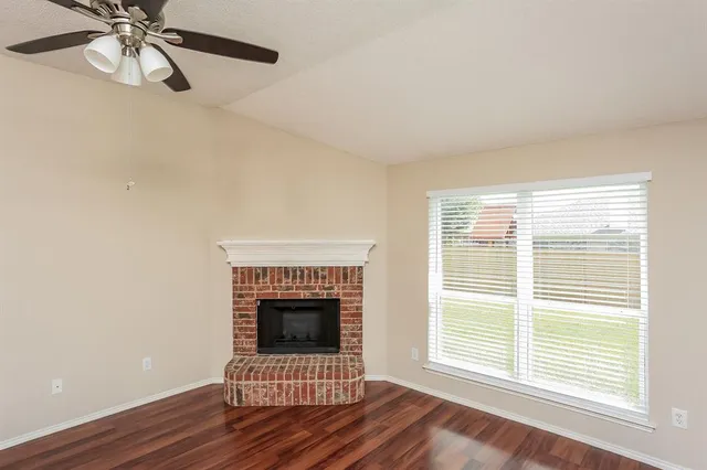 a living room with a fireplace and a window