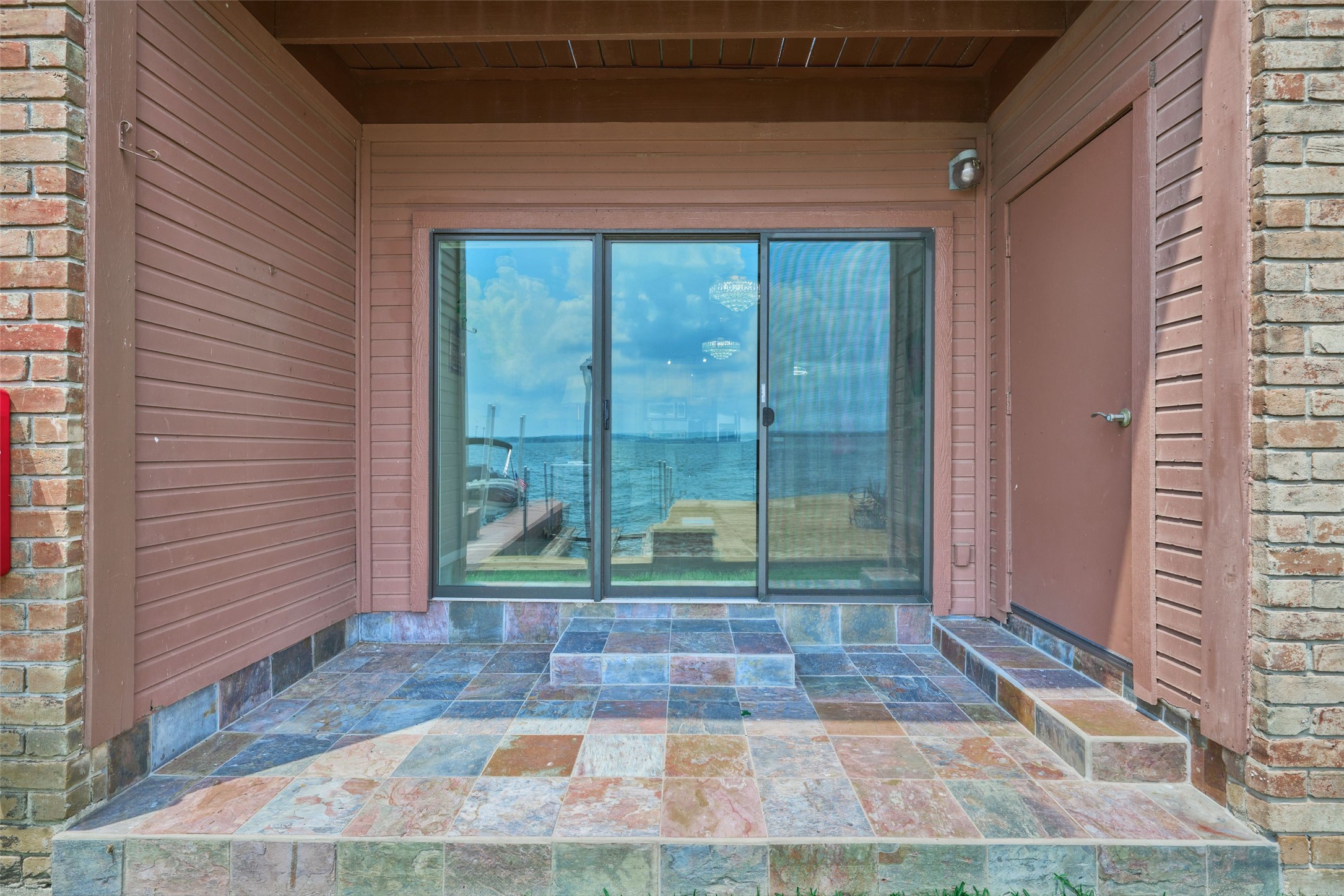 801 River Road, Unit 105D Montgomery, TX 77356 - Photo 27 of 32 Back covered patio features tiled floors & a storage area to keep all your water toys, tools & extras.