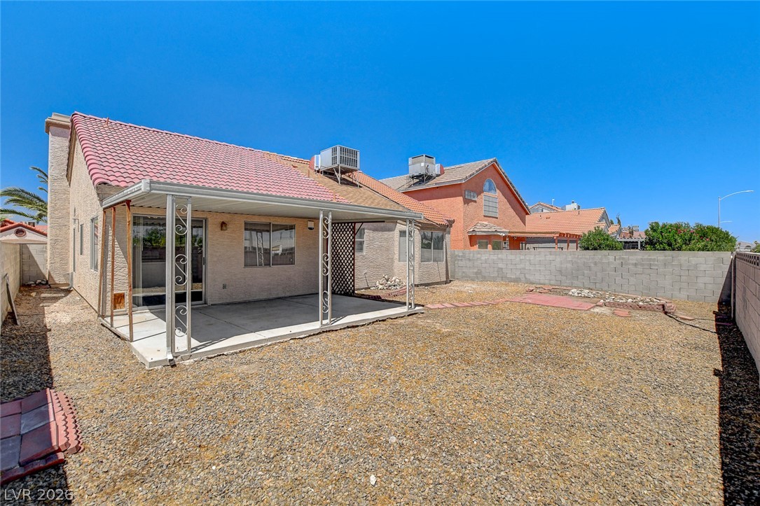 6209 Warm River Road Las Vegas, NV 89108 - Photo 37 of 39 A spacious backyard with covered patio, ideal for outdoor gatherings.