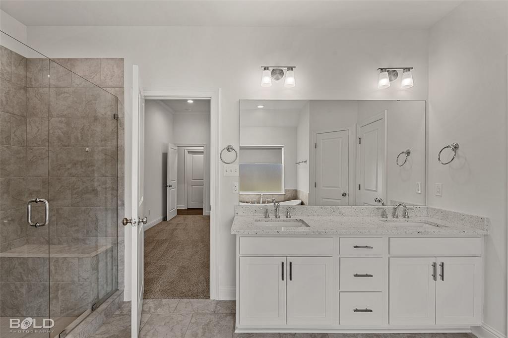 304 Prien Lk Loop Bossier City, LA 71111 - Photo 26 of 39 Dual vanity with white cabinetry and light-toned countertops
