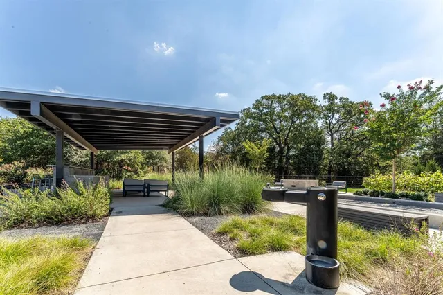 a view of a patio with table and chairs potted plants with wooden floor and fence