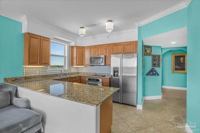 a kitchen with a sink a counter top space cabinets and stainless steel appliances