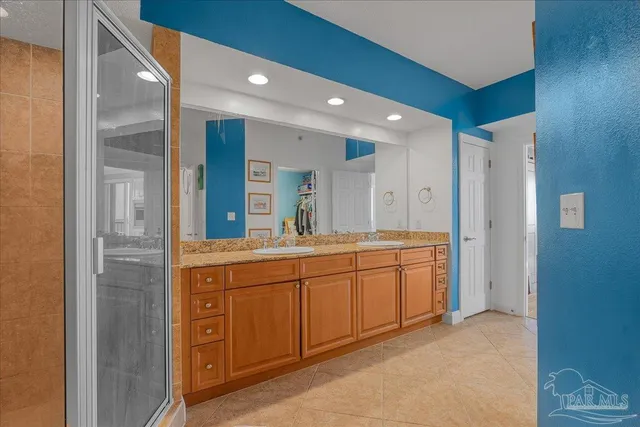 a spacious bathroom with a double vanity sink and a mirror