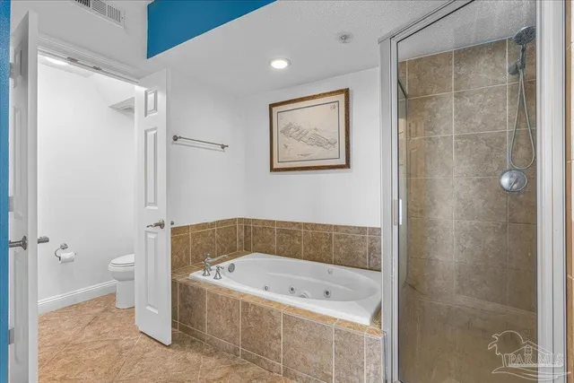 a bathroom with a tub a toilet and a shower