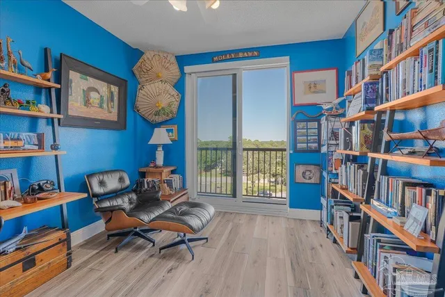 a reading room with furniture book shelf and a rug