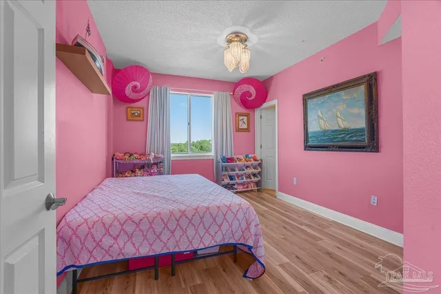 a bedroom with a bed a dresser and couch