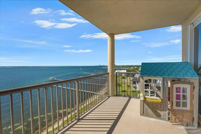 a view of a balcony with floor to ceiling windows with wooden floor