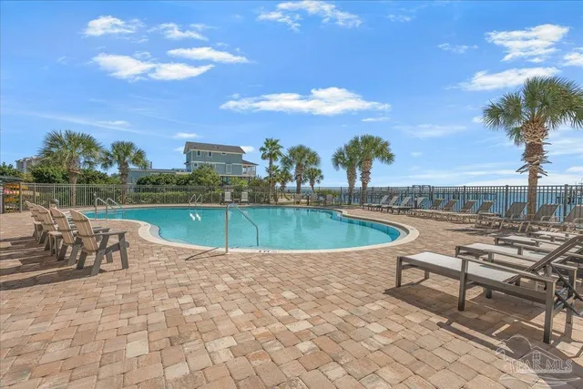 a view of a swimming pool with a lounge chair