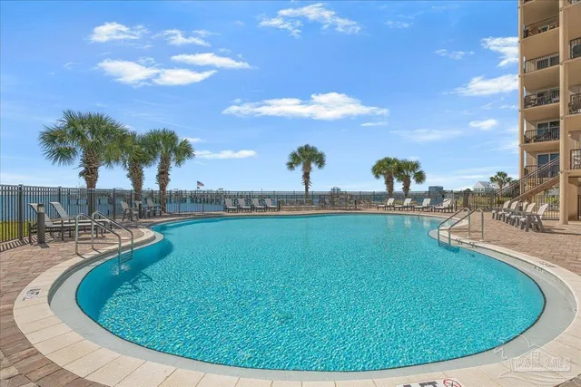 a view of a swimming pool with outdoor seating