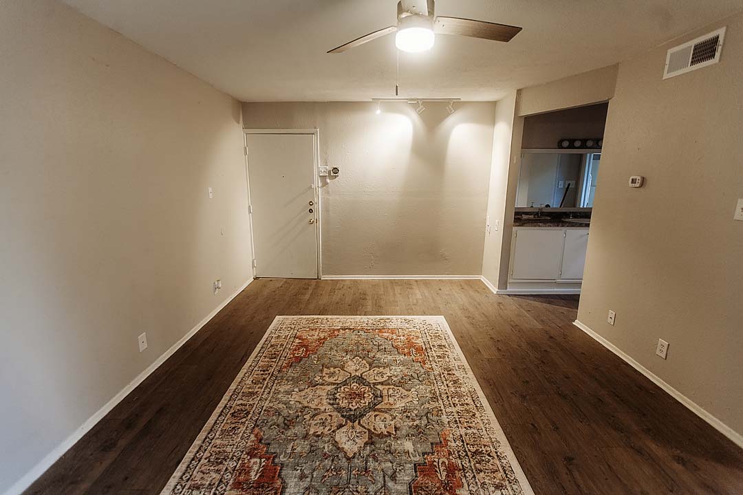 3712 Menchaca Road, Unit 7 Austin, TX 78704 - Photo 6 of 13 Gleaming wood-look floors pair seamlessly with track lighting in this open living area.