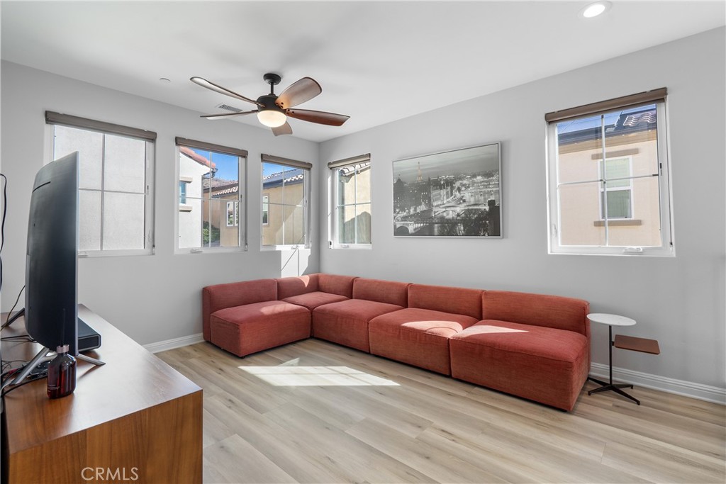 20809 Acorn Circle Porter Ranch, CA 91326 - Photo 15 of 57 a living room with furniture a ceiling fan and a window
