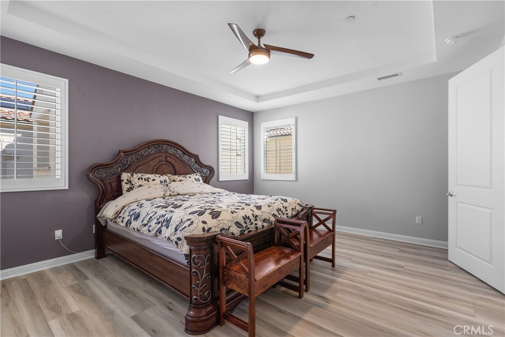20809 Acorn Circle Porter Ranch, CA 91326 - Photo 18 of 57 a bedroom with a bed next to a window with a chandelier