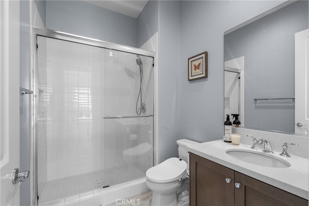 20809 Acorn Circle Porter Ranch, CA 91326 - Photo 30 of 57 a bathroom with a granite countertop sink toilet and shower