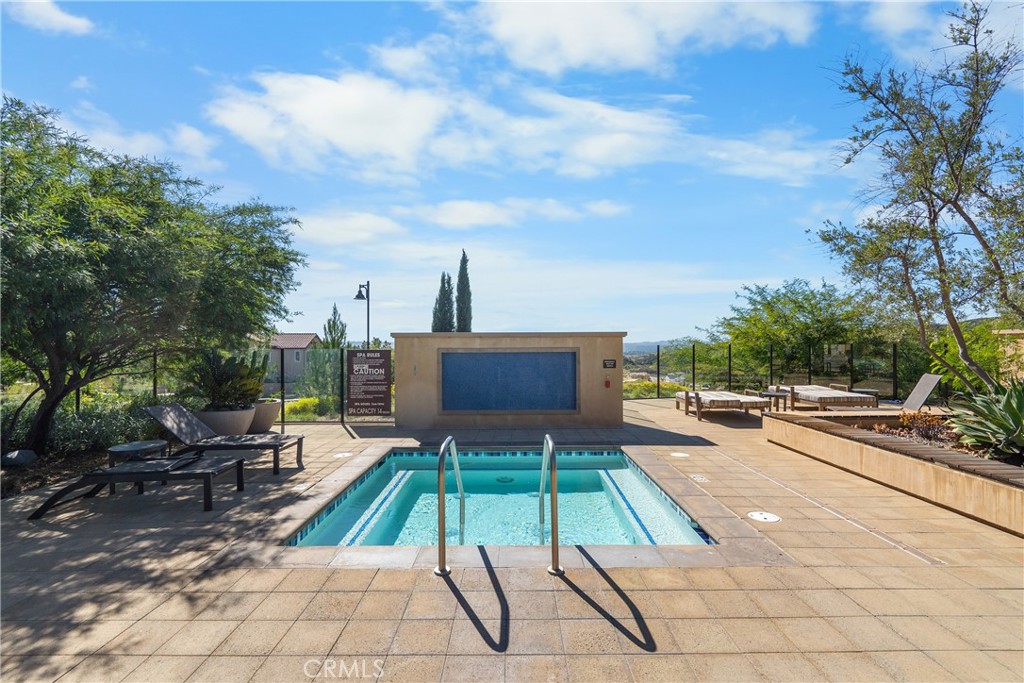 20809 Acorn Circle Porter Ranch, CA 91326 - Photo 53 of 57 a view of a patio with a dining table and chairs with a fire pit