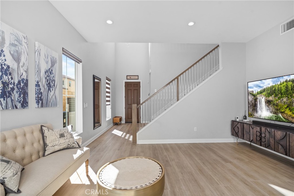 20809 Acorn Circle Porter Ranch, CA 91326 - Photo 10 of 57 a living room with furniture a flat screen tv and a floor to ceiling window