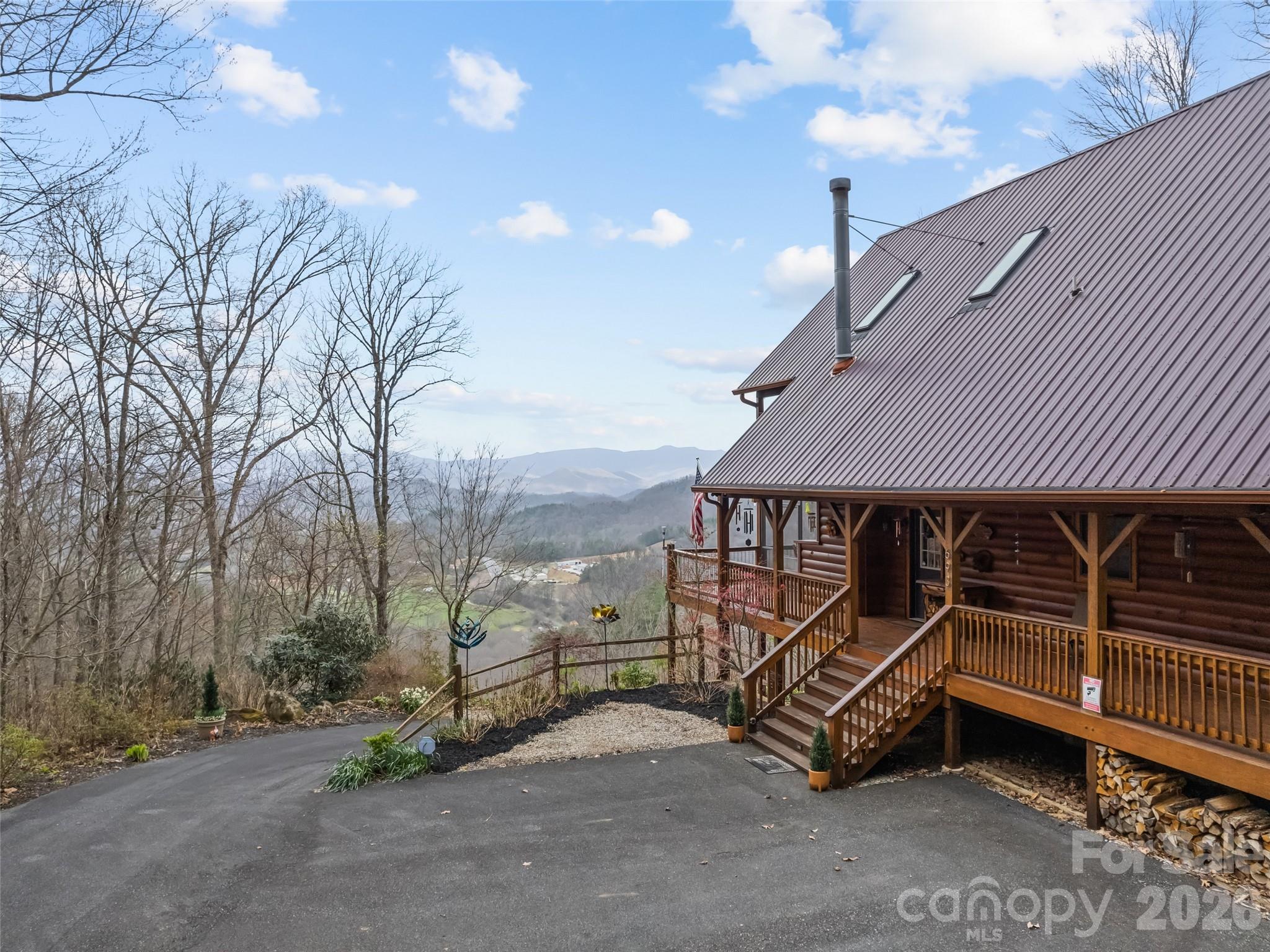 a view of a house with a wooden roof deck