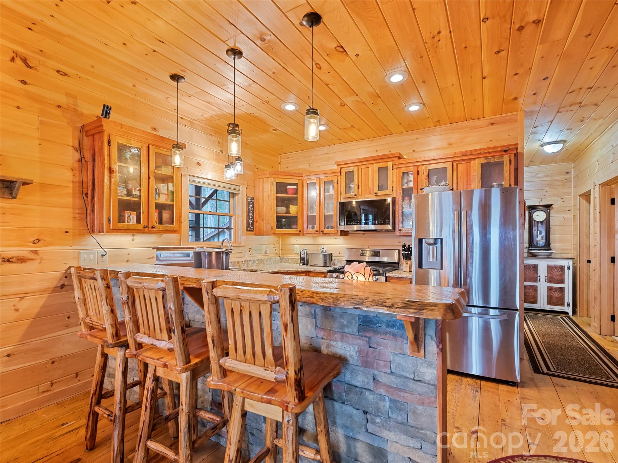 693 High Splendor Drive Robbinsville, NC 28771 - Photo 13 of 48 a open kitchen with stainless steel appliances granite countertop a stove and refrigerator