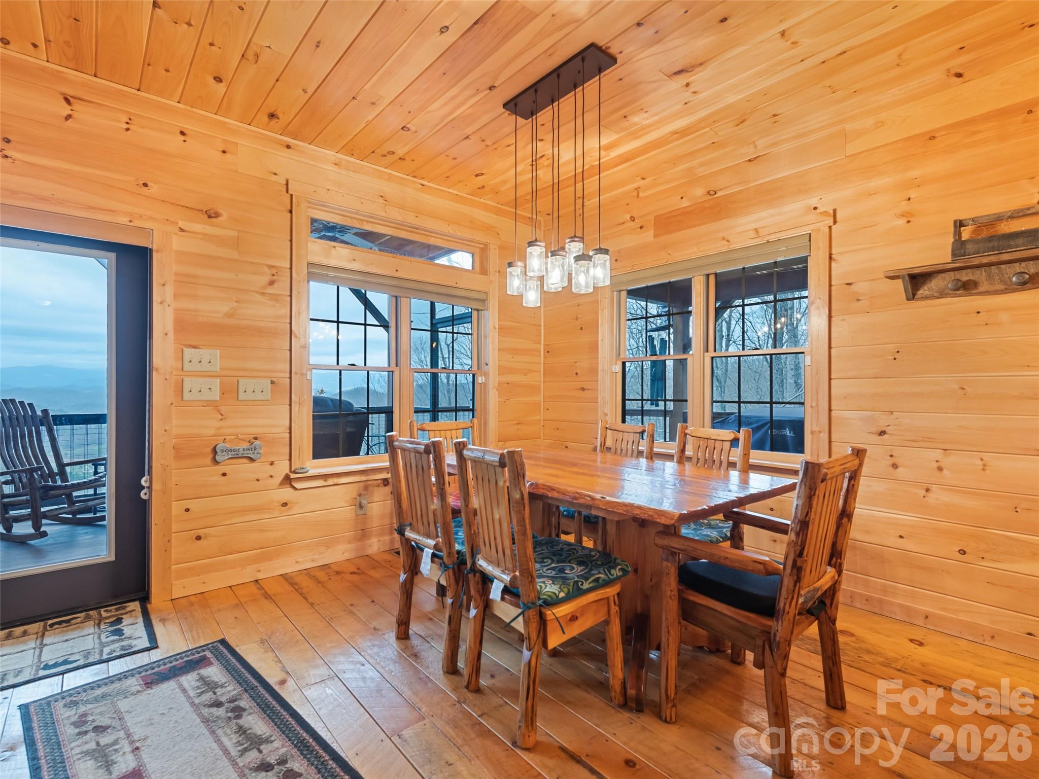 693 High Splendor Drive Robbinsville, NC 28771 - Photo 15 of 48 a view of a dining room with furniture wooden floor and a chandelier