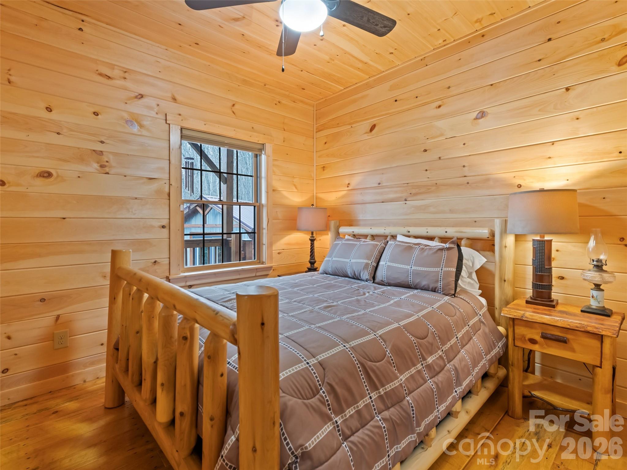 693 High Splendor Drive Robbinsville, NC 28771 - Photo 18 of 48 a bedroom with bed and a chandelier