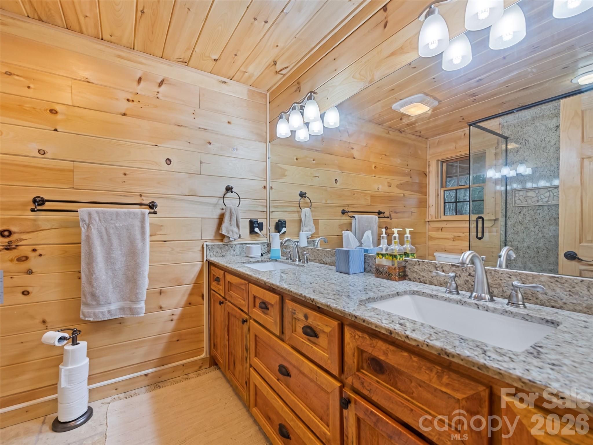 693 High Splendor Drive Robbinsville, NC 28771 - Photo 28 of 48 a bathroom with double vanity and a mirror